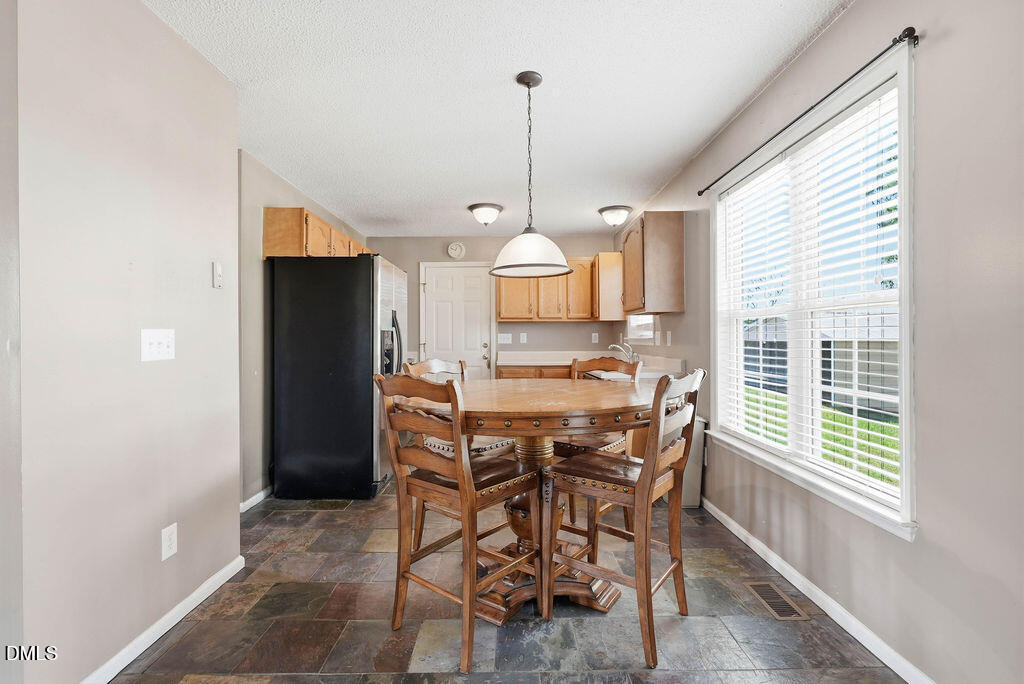 1560 Cane Mill Road Coats, NC 27521 - Photo 13 of 32 a view of a dining room with furniture window and wooden floor