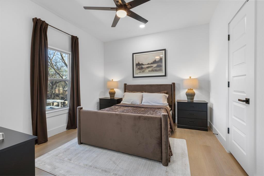 1511 Barry Avenue Dallas, TX 75223 - Photo 11 of 14 a bedroom with a bed and a painting on the wall