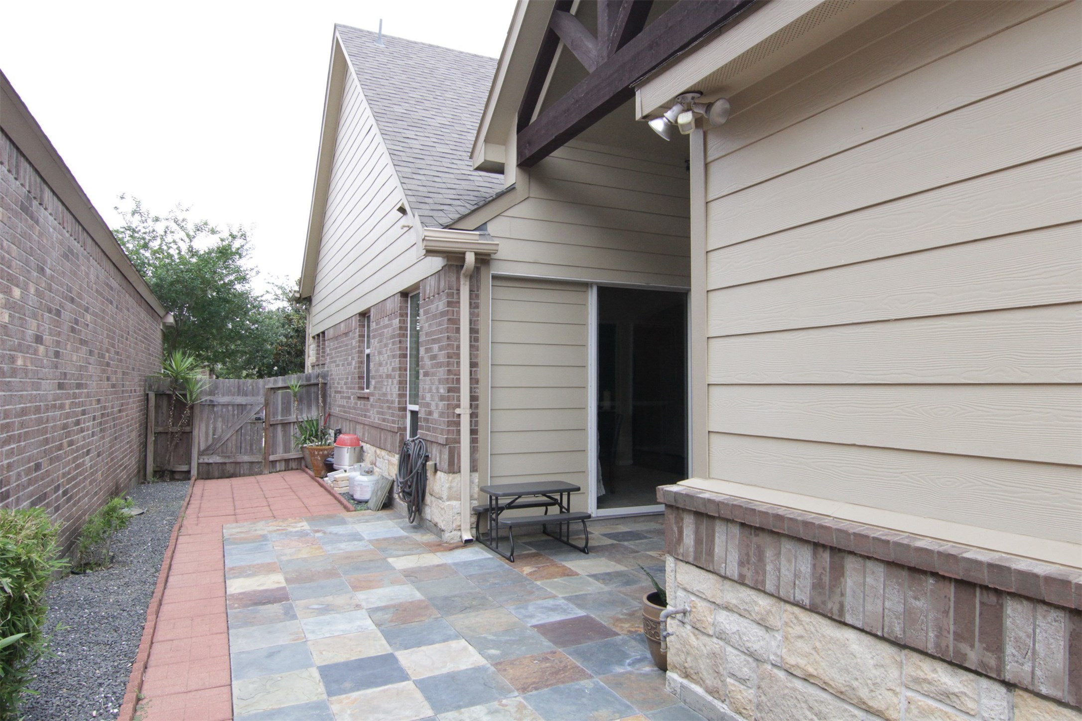 1423 Ralston Branch Way Sugar Land, TX 77479 - Photo 35 of 43 view from side yard of front wooden gate; tenant is responsible for maintaining everything inside the gate