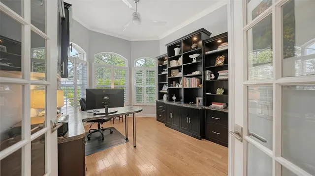 a view of a workspace with furniture and a window