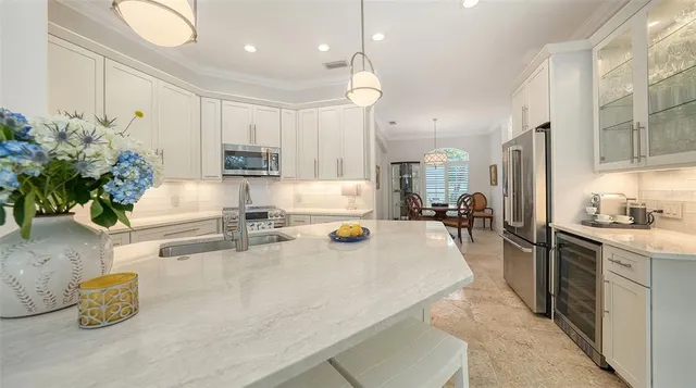 a dining room with furniture a chandelier and window