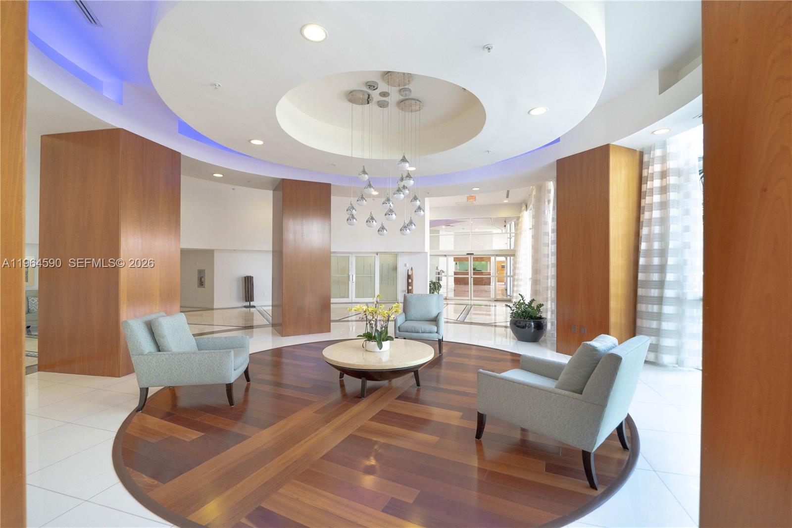 6301 Collins Avenue, Unit 2802 Miami Beach, FL 33141 - Photo 27 of 28 a view of a dining room with furniture and a chandelier