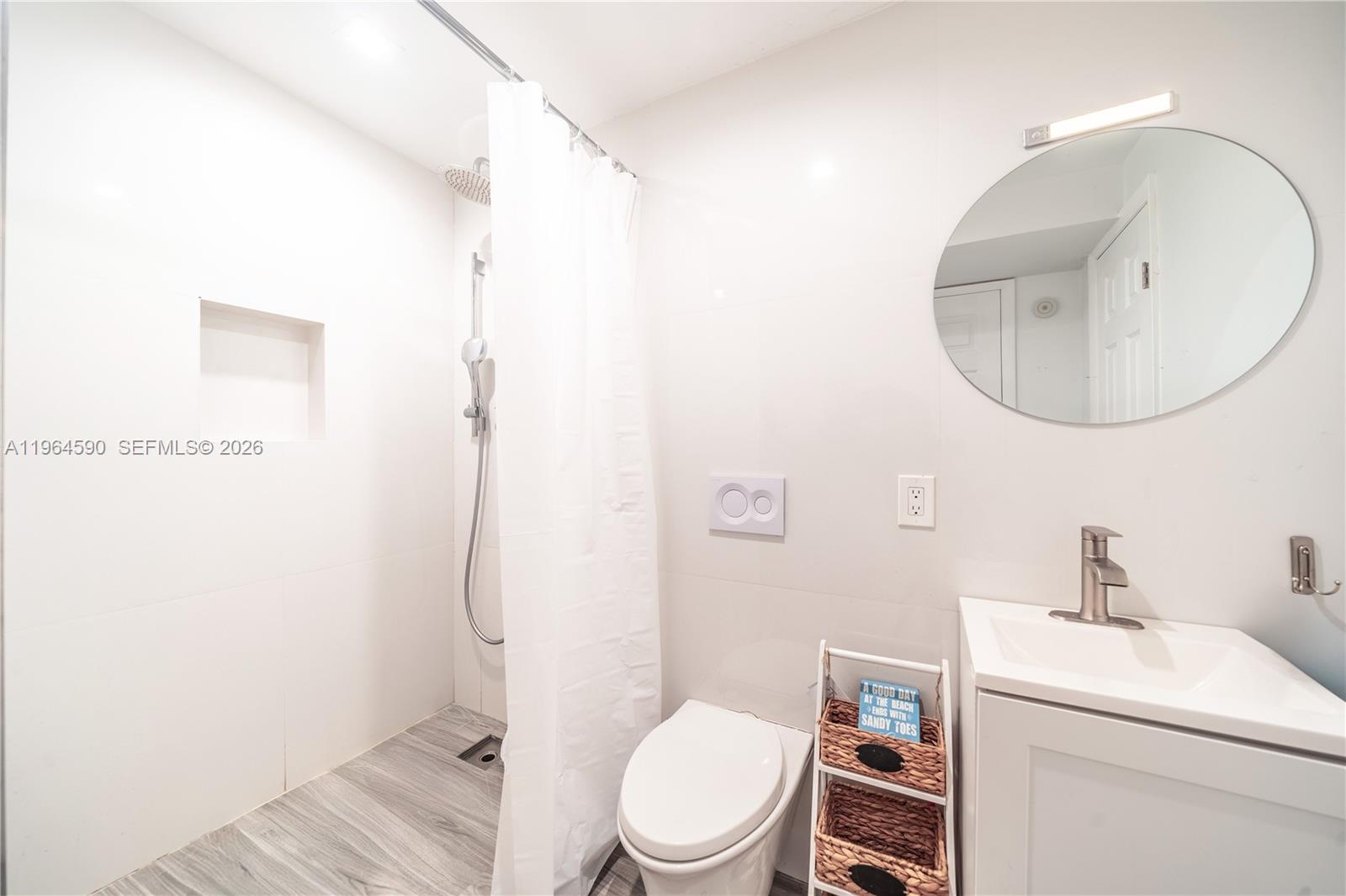 6301 Collins Avenue, Unit 2802 Miami Beach, FL 33141 - Photo 7 of 28 a bathroom with a toilet sink and mirror