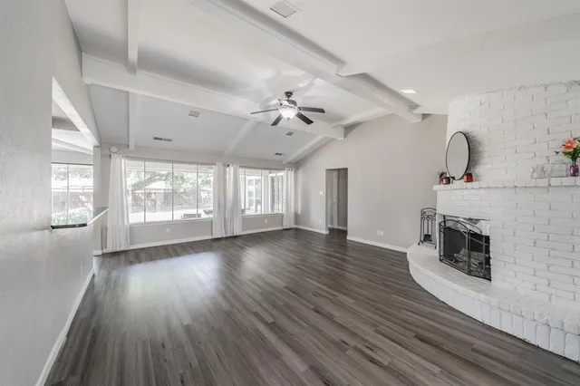 wooden floor in an empty room with a fireplace