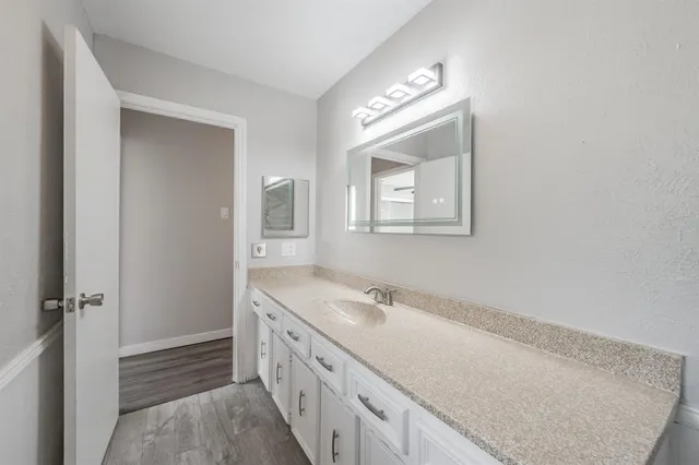 a bathroom with a double vanity sink and mirror