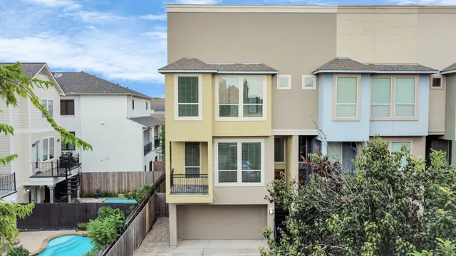a view of residential houses with yard and furniture