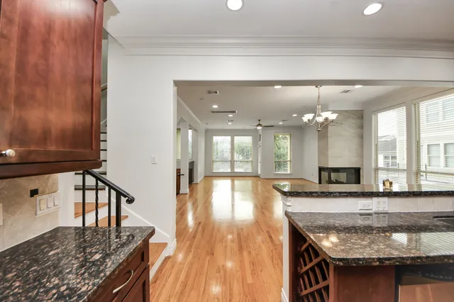 a kitchen with stainless steel appliances granite countertop a stove a sink and a microwave