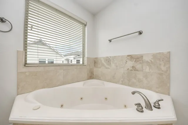 a large kitchen with a sink and cabinets