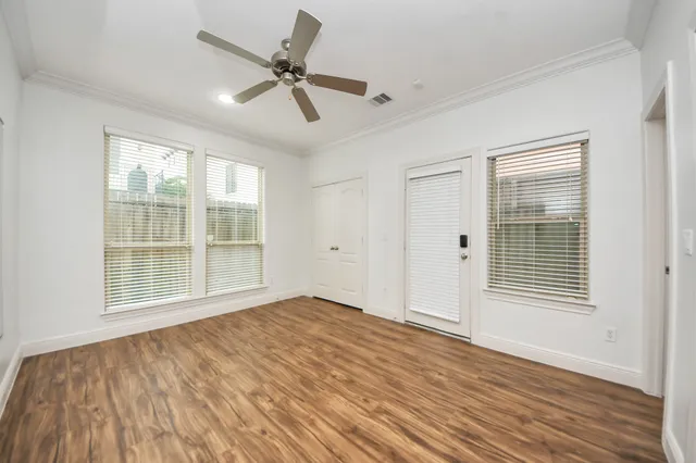 a view of a livingroom with a hardwood floor and ceiling fan