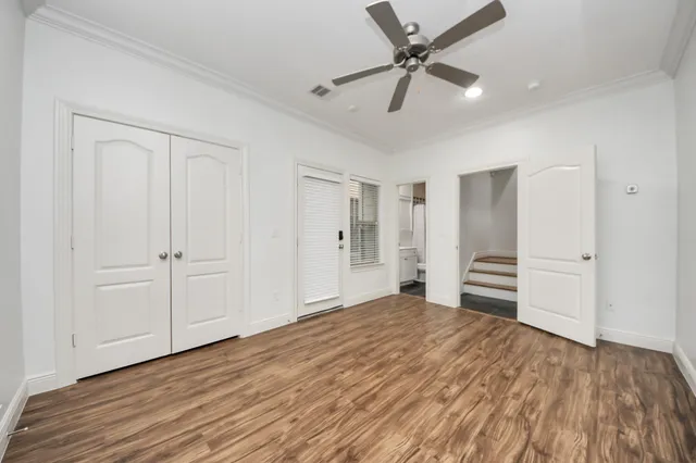 a view of empty room with wooden floor