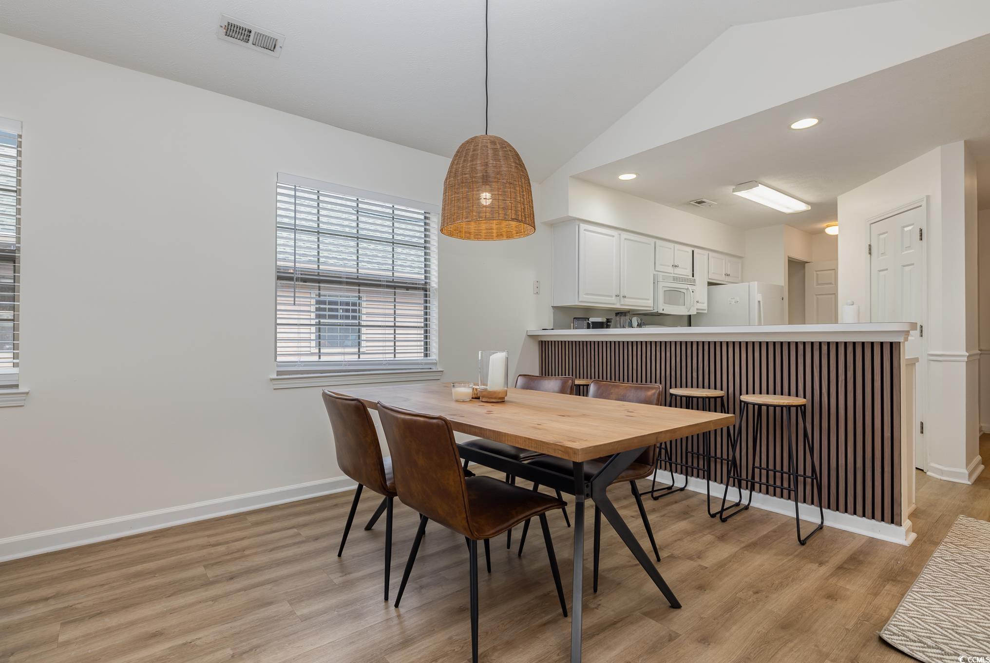 504 Pinehurst Lane, Unit 18H Pawleys Island, SC 29585 - Photo 13 of 28 Dining space featuring recessed lighting, vaulted ceiling, and light wood finished floors