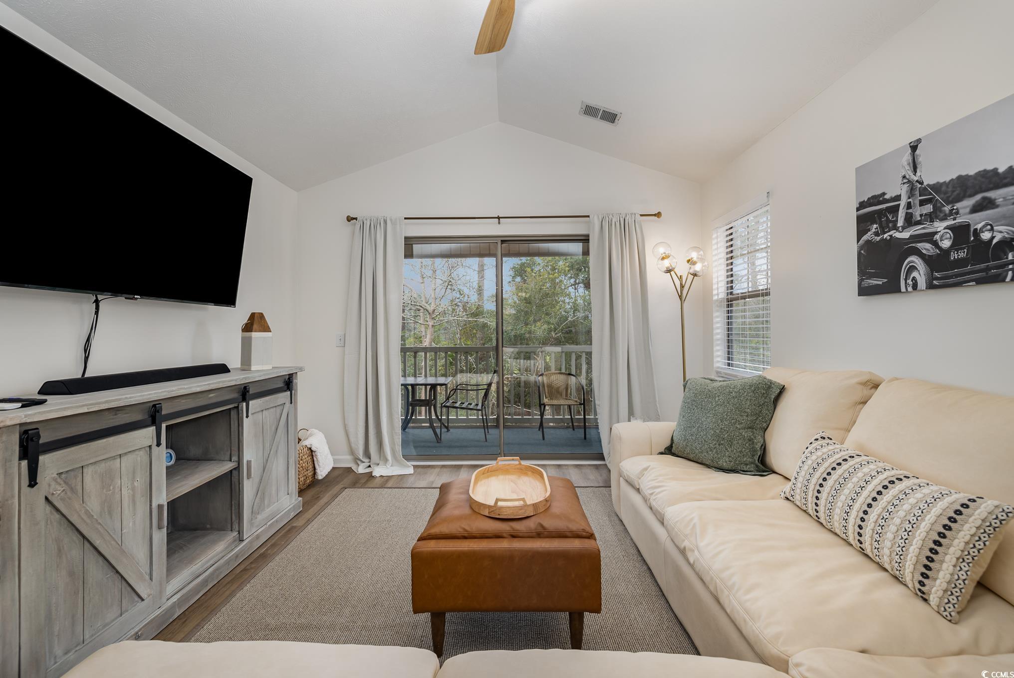 504 Pinehurst Lane, Unit 18H Pawleys Island, SC 29585 - Photo 15 of 28 Living room with vaulted ceiling, wood finished floors, and a ceiling fan