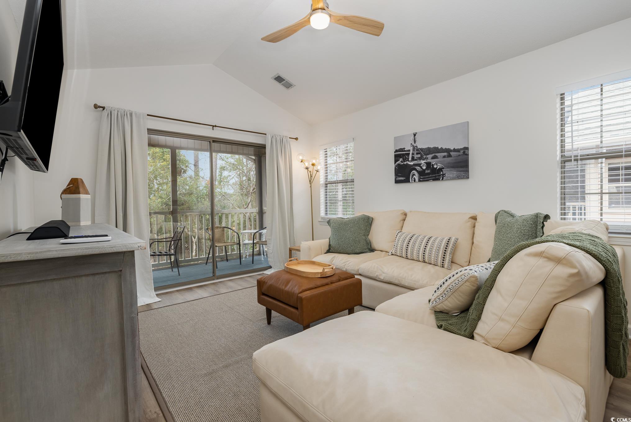504 Pinehurst Lane, Unit 18H Pawleys Island, SC 29585 - Photo 16 of 28 Living area with vaulted ceiling, wood finished floors, and a ceiling fan