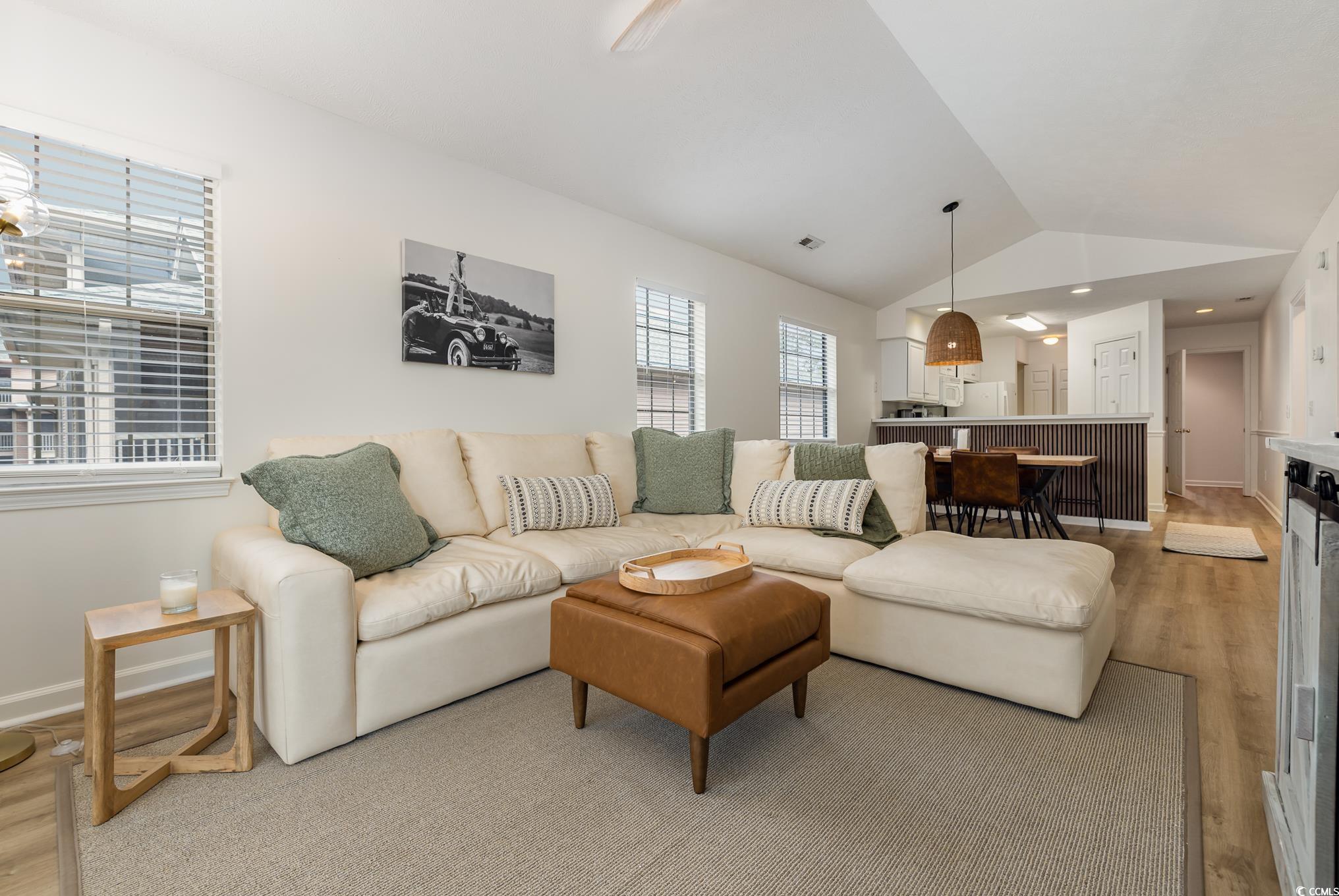 504 Pinehurst Lane, Unit 18H Pawleys Island, SC 29585 - Photo 18 of 28 Living room with light wood-type flooring and vaulted ceiling