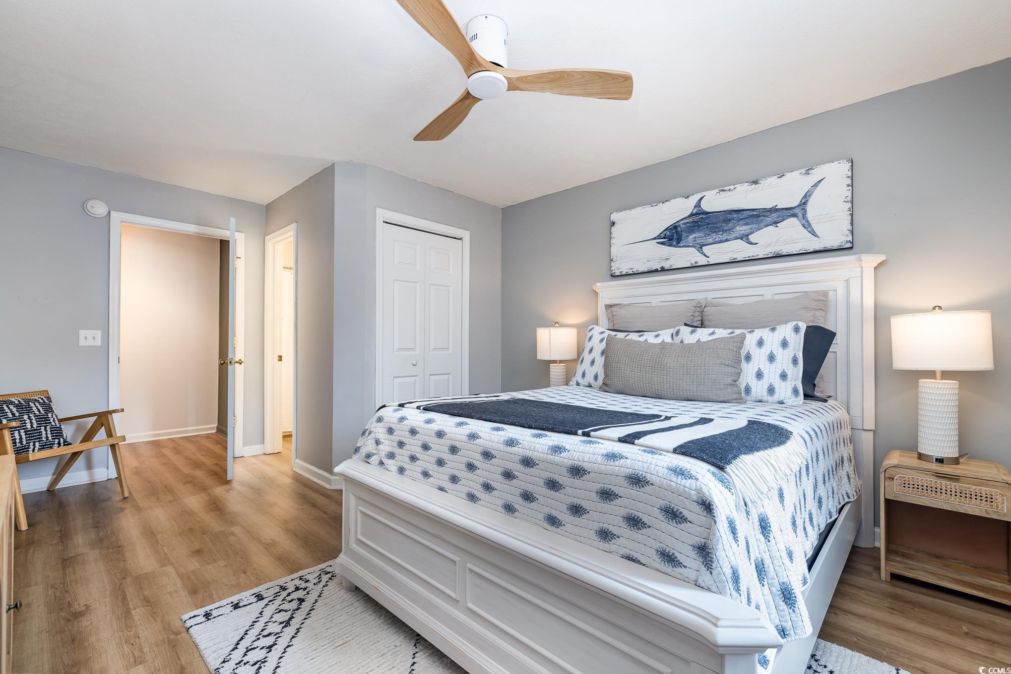 504 Pinehurst Lane, Unit 18H Pawleys Island, SC 29585 - Photo 3 of 28 Bedroom with light wood-style floors, a closet, and ceiling fan