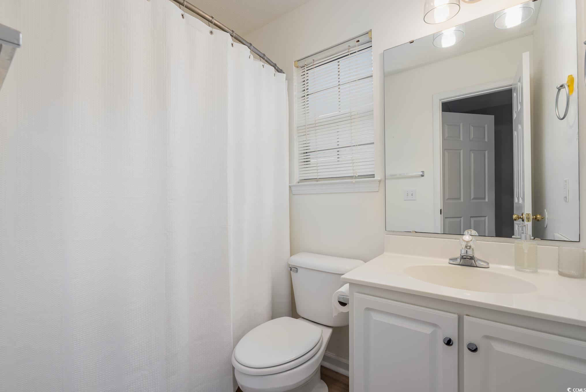 504 Pinehurst Lane, Unit 18H Pawleys Island, SC 29585 - Photo 5 of 28 Bathroom featuring vanity and a shower with curtain