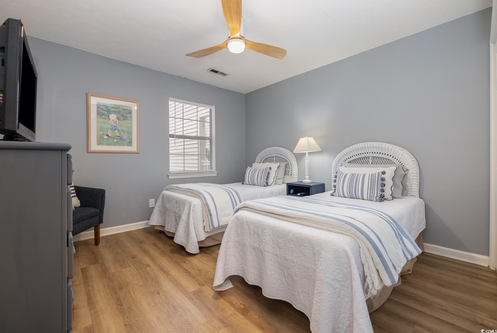504 Pinehurst Lane, Unit 18H Pawleys Island, SC 29585 - Photo 6 of 28 Bedroom with light wood finished floors and ceiling fan