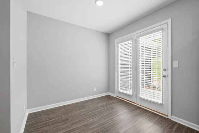 a view of wooden floor and windows in a room