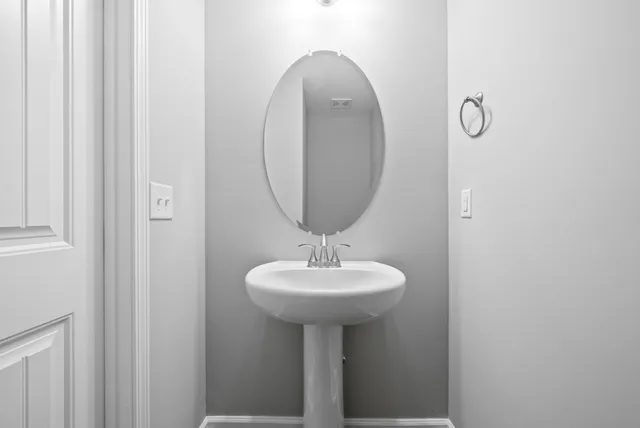 a bathroom with a sink a mirror and a window