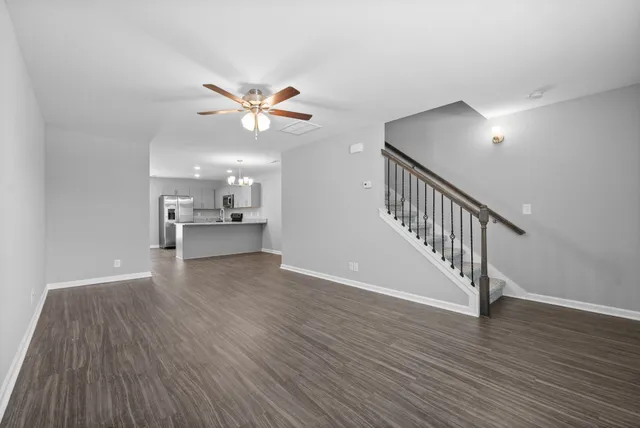 a view of an empty room and wooden floor