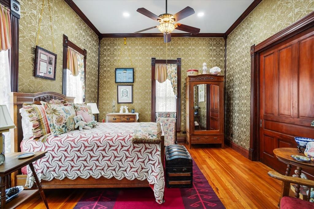 300 West 6th Street Bonham, TX 75418 - Photo 15 of 40 a bedroom with a bed and wooden floor