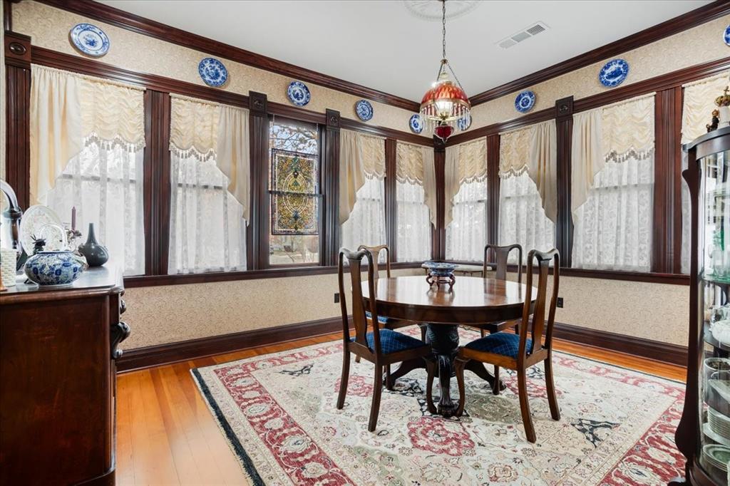 300 West 6th Street Bonham, TX 75418 - Photo 22 of 40 a view of a dining room with furniture large windows and wooden floor
