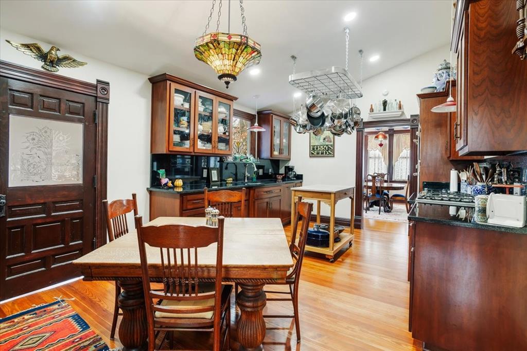 300 West 6th Street Bonham, TX 75418 - Photo 27 of 40 a view of a dining room with furniture a chandelier and wooden floor
