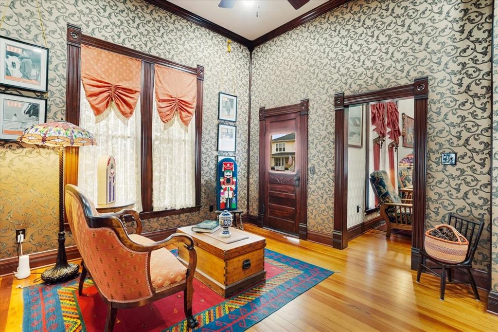 300 West 6th Street Bonham, TX 75418 - Photo 33 of 40 a living room with blue lights with furniture and large window