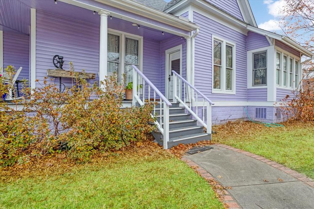 300 West 6th Street Bonham, TX 75418 - Photo 6 of 40 a view of brick house with a small yard and plants