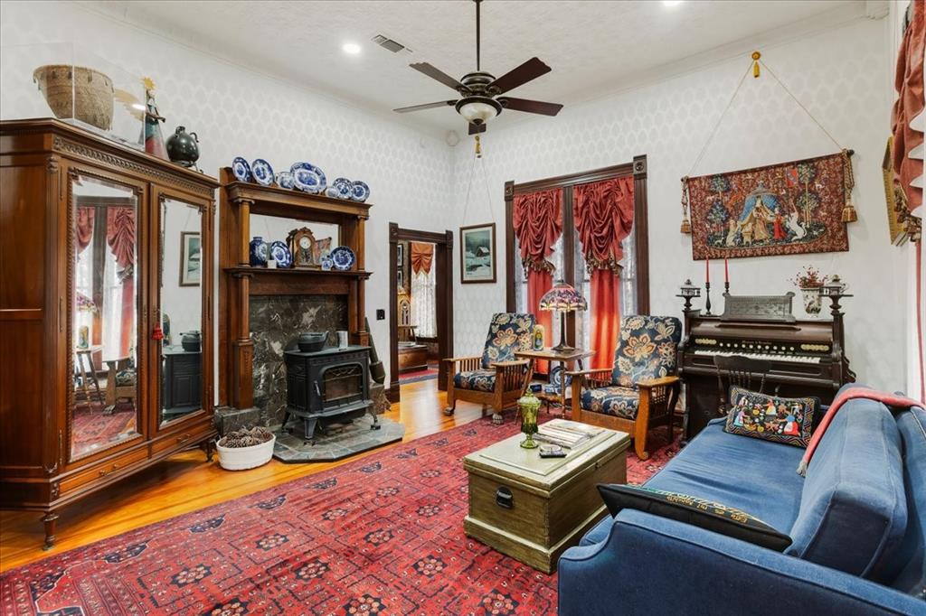 300 West 6th Street Bonham, TX 75418 - Photo 8 of 40 a living room with furniture a flat screen tv and a fireplace