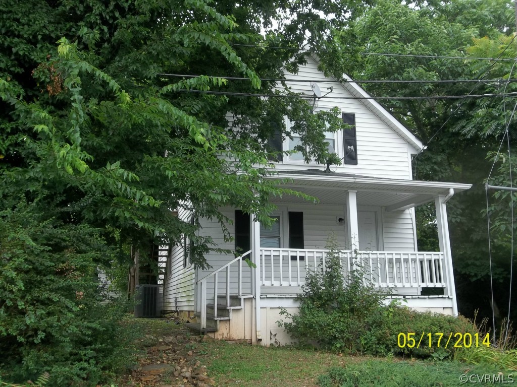 a view of white house with a yard