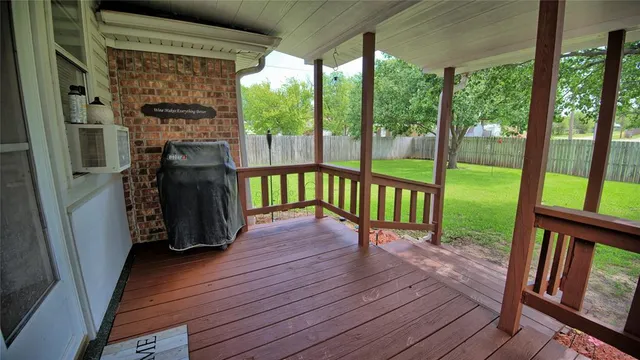 a view of front door deck and hardwood floor