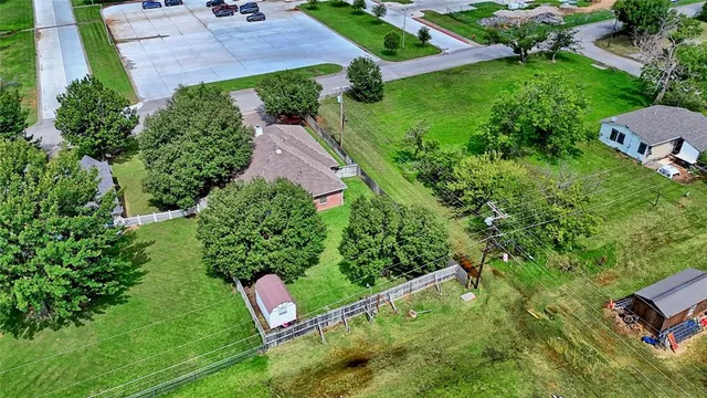 an aerial view of a house with garden space and street view