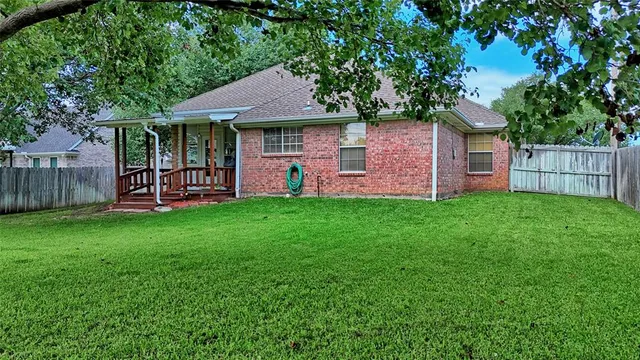 a front view of a house with a garden and yard