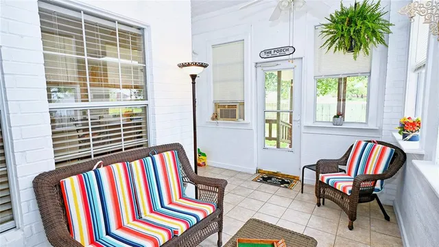 a front view of a bedroom with furniture and windows