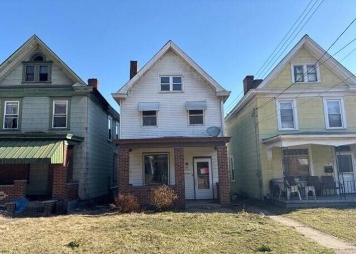 406 Grove Street McKees Rocks, PA 15136 - Photo 1 of 14 a front view of a house with a yard and garage