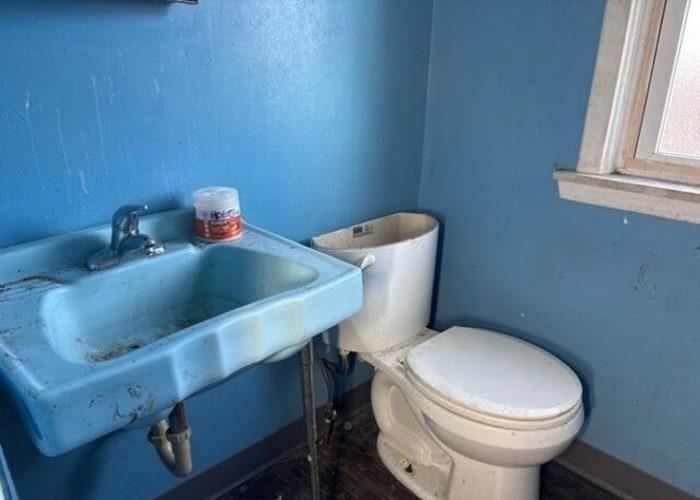 406 Grove Street McKees Rocks, PA 15136 - Photo 14 of 14 a white toilet sitting next to a bathroom sink
