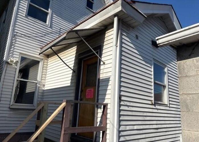 406 Grove Street McKees Rocks, PA 15136 - Photo 3 of 14 a view of a house with a large window