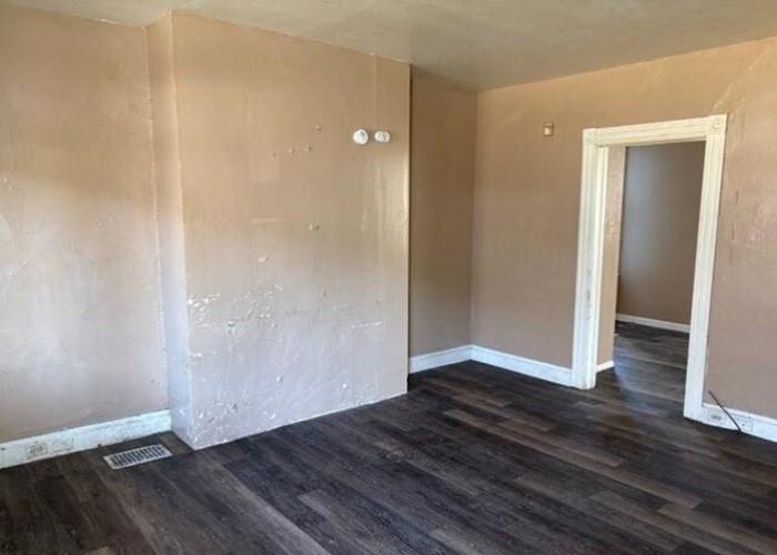 406 Grove Street McKees Rocks, PA 15136 - Photo 5 of 14 a view of an empty room with wooden floor and closet
