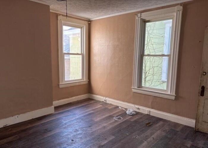 406 Grove Street McKees Rocks, PA 15136 - Photo 7 of 14 a view of an empty room with wooden floor and a window