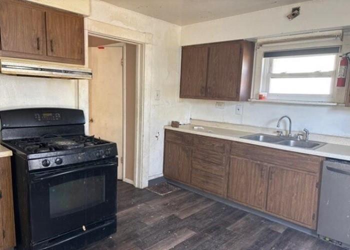 406 Grove Street McKees Rocks, PA 15136 - Photo 10 of 14 a kitchen with stainless steel appliances granite countertop a stove a sink and a microwave