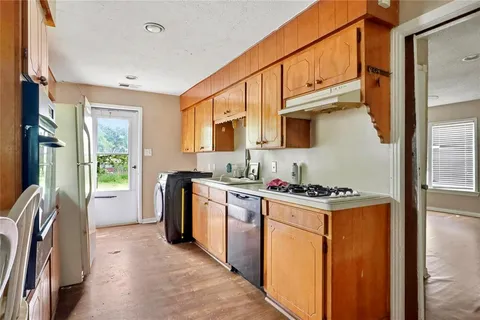 a kitchen with stainless steel appliances granite countertop a stove top oven