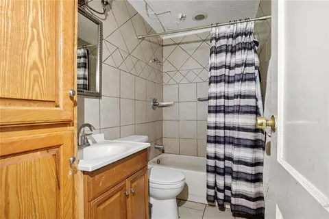 a bathroom with a shower toilet and sink
