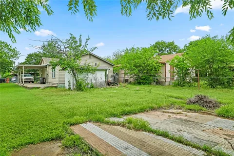 a view of a house with yard and a garden
