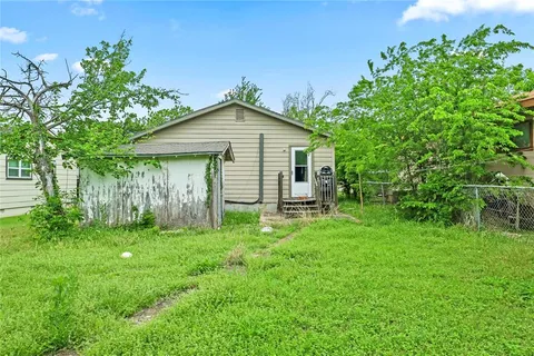 a front view of a house with yard and green space