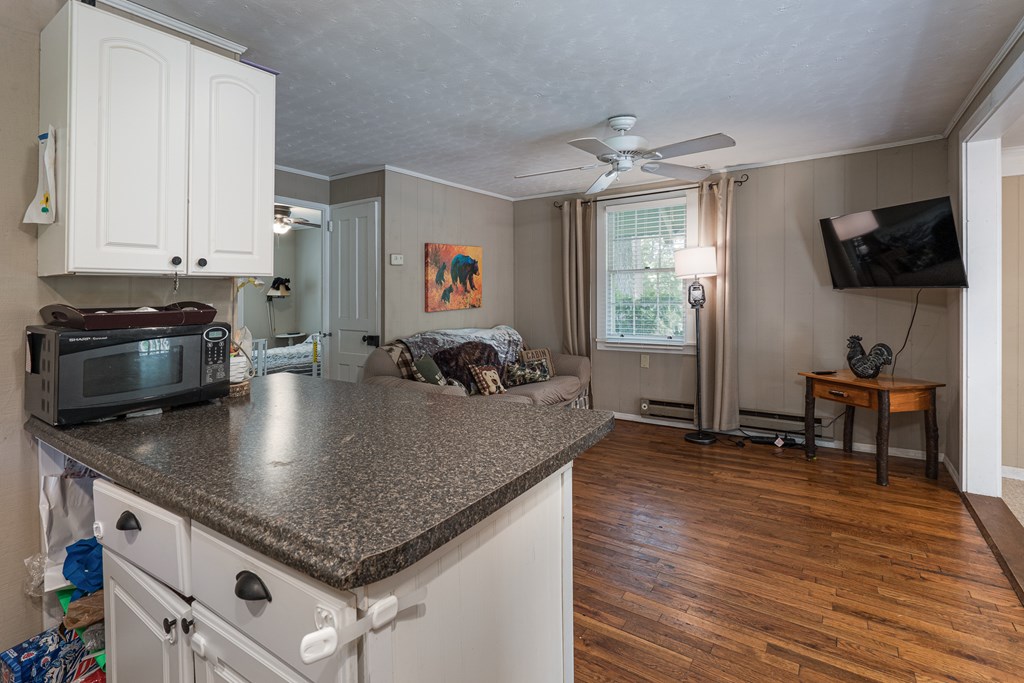 275 Village Road Murphy, NC 28906 - Photo 20 of 47 a kitchen with stainless steel appliances granite countertop a sink dishwasher and a stove with wooden floor