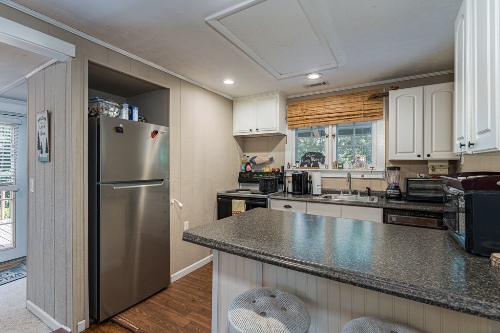 275 Village Road Murphy, NC 28906 - Photo 21 of 47 a kitchen with a refrigerator a sink and cabinets