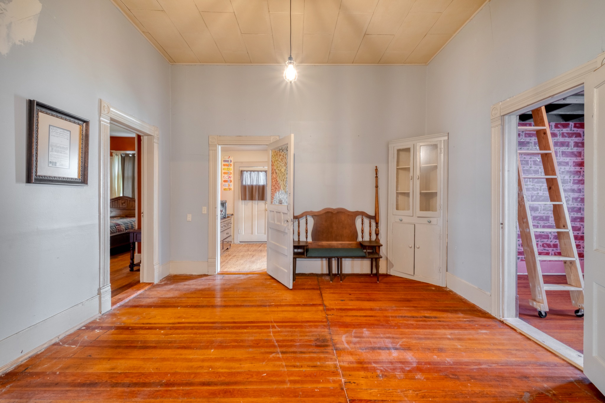 300 South Rio Grande Street Granger, TX 76530 - Photo 7 of 25 Hallway featuring light wood-type flooring and a high ceiling