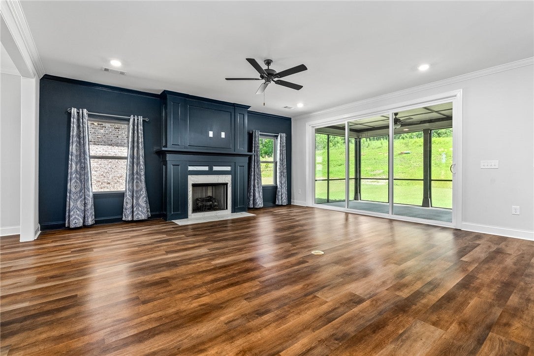 3053 Mimms Trl Road Auburn, AL 36832 - Photo 7 of 45 The great room features a gas fireplace flanked by windows and a wall of windows with a sliding door that opens to a screened porch.
