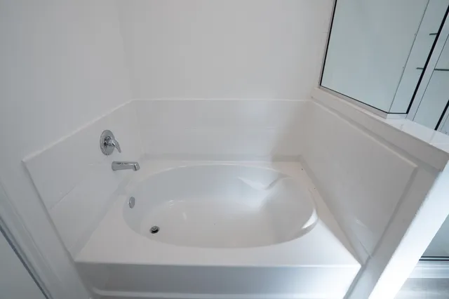 a white bath tub sitting in a bathroom
